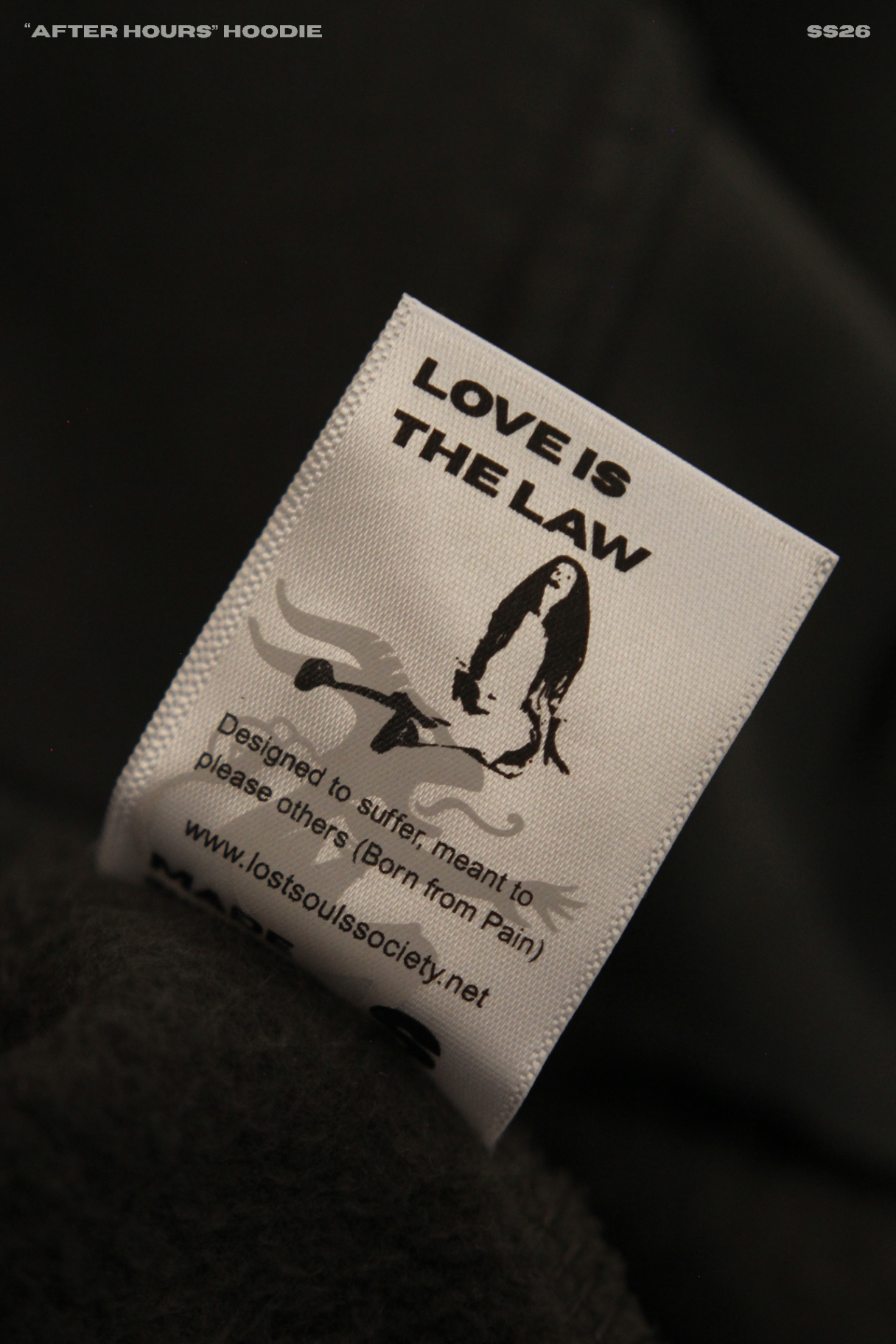 Frame 02 — "Love is the Law" woven label